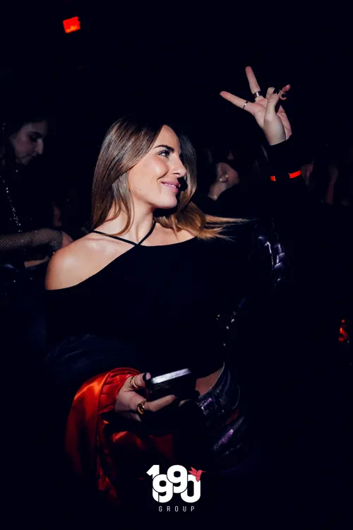 Woman enjoying the Fuego Thursdays party hosted by 1990 Group at a nightclub in New York.