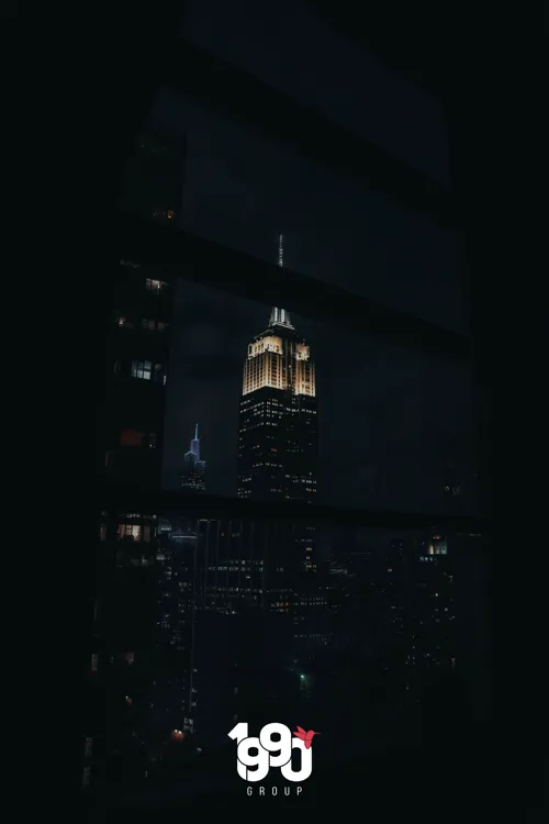 Night view of the Empire State Building from a window, exclusive event by 1990 Group in New York.