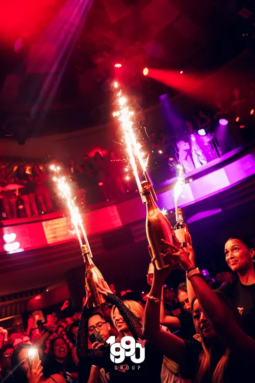 Champagne bottles with sparklers at a night celebration in New York, organized by 1990 Group.