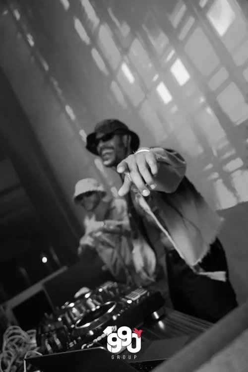 DJ pointing at the camera during a party at a New York club, at an event organized by 1990 Group.