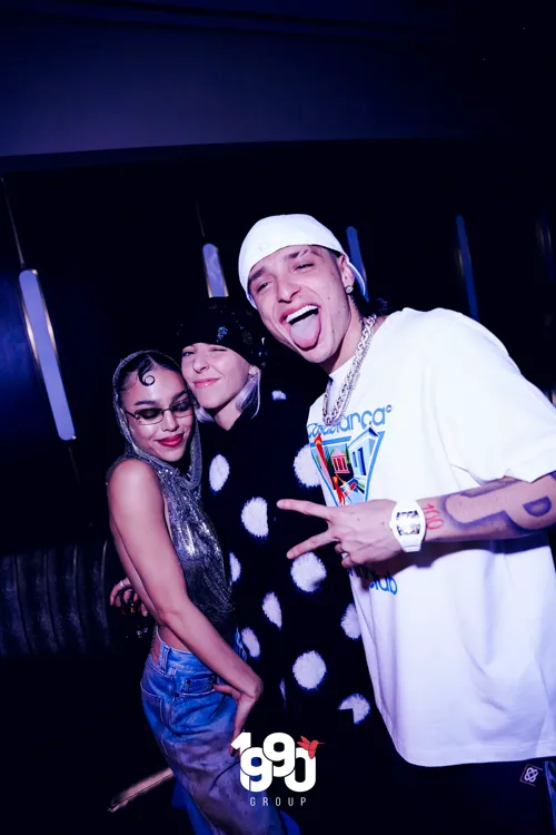 Artists Peso Pluma and Young Miko posing for a photo at a New York party, organized by 1990 Group.